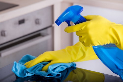 Professional cleaner treating a dining chair during upholstery cleaning in Stjohnswood